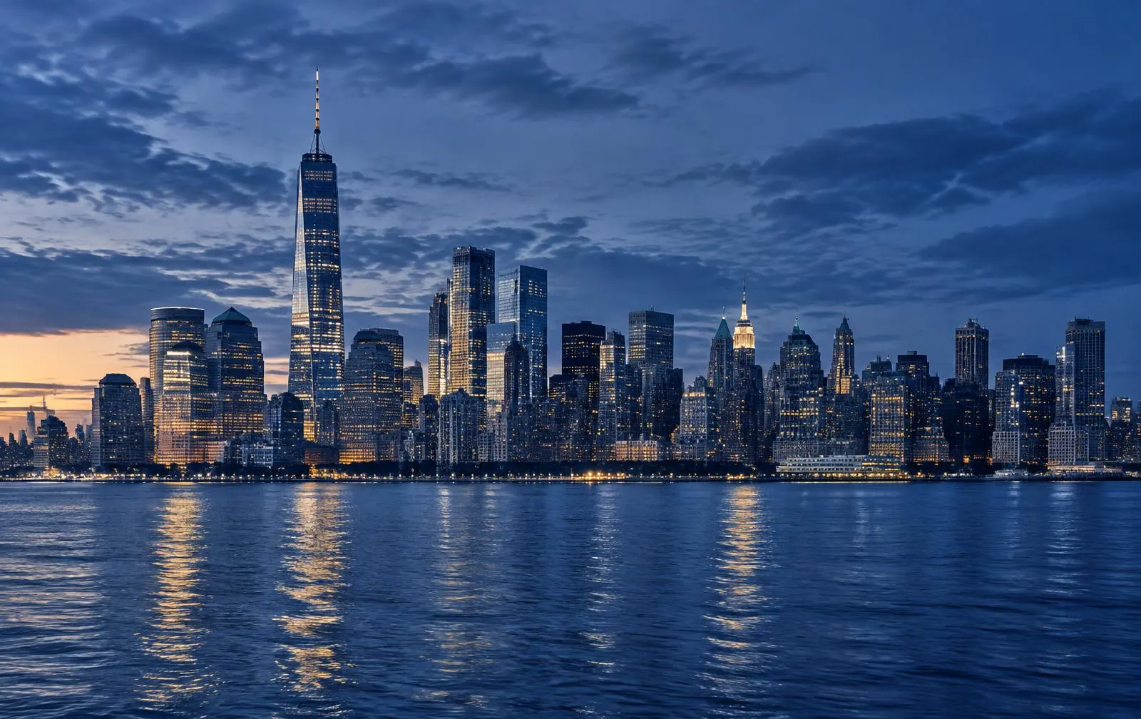 Manhattan skyline at dusk across the Hudson from New Jersey.